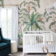 a white crib in front of a wall with jungle mural