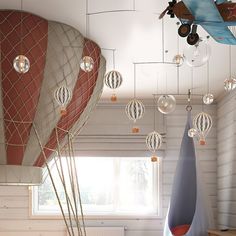 a room with hot air balloons hanging from the ceiling