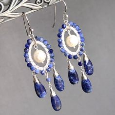 7424 Sodalite White Pearls Earrings Sterling Silver wire wrapped natural blue gemstones bohemian statement chandeliers birthday anniversary Mother's day Christmas holiday gift for her women mom sister wife girlfriend daughter niece aunt grandma cousin colleague best friend. Enjoy the beauty & power of natural gemstones. MATERIALS & DIMENSIONS ✦ Natural SODALITE, indigo blue, smooth teardrops approx. 15x7mm, faceted round beads 3mm; ✦ Freshwater PEARLS, white, faceted rounds approx. 9mm; ✦ STERLI Bohemian Gemstone Dangle Chandelier Earrings, Bohemian Gemstone Chandelier Dangle Earrings, Bohemian Gemstone Chandelier Earrings, Bohemian Sterling Silver Gemstone Chandelier Earrings, Bohemian Sterling Silver Chandelier Earrings With Natural Stones, Bohemian Wire Wrapped Long Drop Chandelier Earrings, Handmade Bohemian Kyanite Jewelry, Bohemian Sterling Silver Wire Wrapped Chandelier Earrings, Bohemian Gemstone Chandelier Drop Earrings