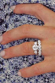 a woman's hand with a diamond ring on it