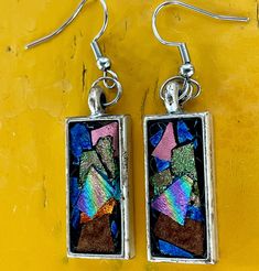 Add to touch of elegance to your look with our handmade, rainbow holographic rectangular earrings. These earrings feature silver pendants with vibrant colors, including blue, pink, gold and bronze. The mesmerizing holographic effect create a unique, one-of-a-kind look that will set you apart. These earrings also make an excellent gift for those who appreciate distinctive handcrafted jewelry. Rectangular Earrings, Rainbow Holographic, Silver Pendants, Earrings Silver, Pink Gold, Handcrafted Jewelry, Silver Pendant, Favorite Jewelry, Jewelry Earrings Dangle