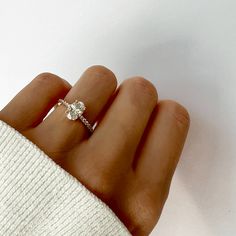 a woman's hand with a diamond ring on it