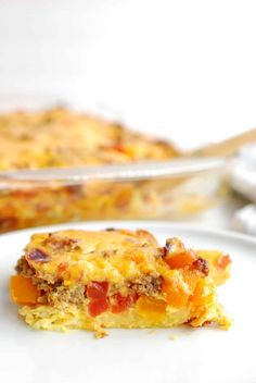 a slice of breakfast casserole on a plate with a serving dish in the background