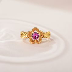 The fashion ring features a sparkling center stone with sculpted petals of a flower, and meaningful engravings inside the band. Give her this masterpiece as a gift to make her feel loved, cared for and pampered.Weight: 3.5 gHeight: 10.25 mmMaterial: 925 SilverPlating Color: Yellow Gold Elegant Flower-shaped Diamond Cut Rings, Elegant Pink Flower Ring For Anniversary, Elegant Flower Shaped Ring For Anniversary, Elegant Flower Ring For Anniversary, Elegant Pink Flower Rings, Elegant Pink Flower Shaped Rings, Elegant Pink Flower-shaped Rings, Flower-shaped Rings With Accent Stones For Anniversary, Elegant Flower Ring With Birthstone For Anniversary