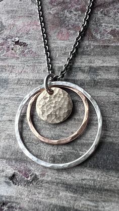 Handcrafted artisan gemstone and sterling silver jewelry by metalsmith Katherine Wise. For more information and a behind-the-scenes look, visit Wise Handmade Jewelry. wisehandmade.com | wisehandmadejewelry.etsy.com Circle Pendant Necklace, Hammered Gold, Handmade Jewelry Gift, Hammered Silver, Circle Pendant, Necklace Handmade, Handmade Artisan, Gold And Silver, Handmade Necklaces