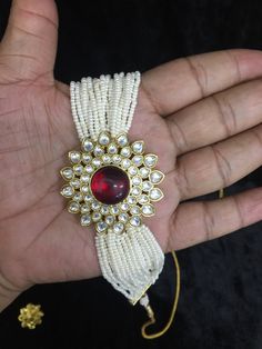 A Kundan pendant with a red stone at the center wrapped between multiple pearl strings sits comfortably on your neck. You look divine in the ethnic mix of white and red. The choker necklace paired with the Kundan crafted earrings is a perfect combo to be worn at festivities Diameter of earrings: 2.5 cms, push back closure  The necklace comes with a Dori and is adjustable Pearl Strings, Crafted Earrings, Pearl Choker, Red Stone, Wedding Jewelry Sets, White And Red, Jewelry Sets, Wedding Jewelry, Etsy Earrings