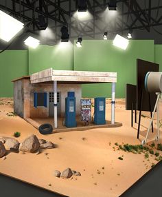 a model of a gas station in the middle of a desert with rocks and dirt