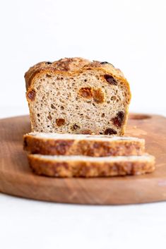 a loaf of bread sitting on top of a wooden cutting board