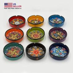 nine colorful bowls with designs on them are arranged in a circle and one is empty