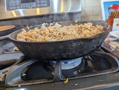 a frying pan filled with food sitting on top of an open stovetop oven