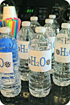 several bottled water bottles with labels on them