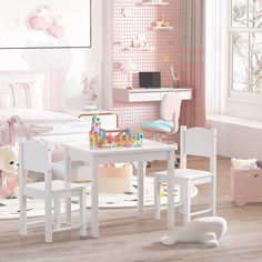 a child's play table and chairs in a room with pink walls, flooring and rugs