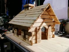 a small wooden house sitting on top of a table