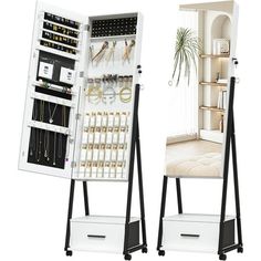 two white and black stands with jewelry on them, one is open and the other has drawers