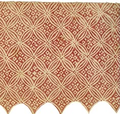 an old piece of cloth with intricate designs on the edges and sides, in red