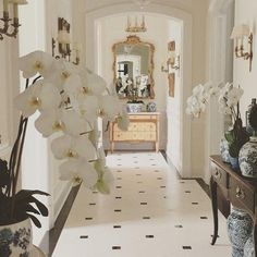 the hallway is decorated with white flowers and vases