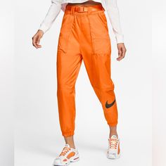 Modern, Street-Ready Style. Featuring Bold A Swoosh Graphic And Ripstop Woven Material, The Nike Sportswear Swoosh Pants Give You Lightweight Comfort And Modern, Street-Ready Style. A Paneled Design With Ripstop Pockets. Casual Orange Sports Pants, Nike Streetwear Pants For Spring, Orange Athleisure Pants With Pockets, Sporty Orange Bottoms For Streetwear, Sporty Orange Pants For Streetwear, Spring Athleisure Orange Bottoms, Orange Sportswear Bottoms For Sports, Orange Sports Bottoms For Spring, Orange Streetwear Pants With Elastic Waistband