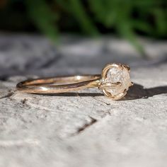 a diamond ring sitting on top of a rock