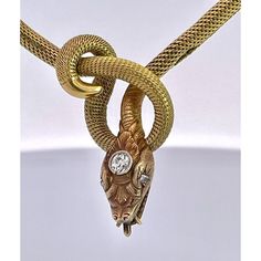 This is part of Chairish’s Fine Jewelry assortment.  This piece is from the early 1900's and is very special as it is longer than most snake necklaces. Women were much smaller then, so most are 13" to 15" necklaces.  This necklace is 16" plus the drop for the snakes head. Perfect for most women. This snake has a beautiful carved and detailed face with a 0.20 point Diamond on his head. This is marked 750 and weighs in at 24.62 grams of gold.  I just love snake jewelry as many of you now but seldom do I purchase these snake necklaces because they are too small for most.  Unless they are 16" or better I let them go.  This one fits the bill as it is 16" plus the drop for the snakes head. Elegant Snake-shaped Jewelry For Formal Occasions, Vintage Snake-shape Jewelry For Formal Occasions, Vintage Yellow Gold Snake Jewelry, Gold Snake-shaped Engraved Necklace, Gold Snake Necklace With Engraving, Antique Gold Diamond Necklace For Formal Occasions, Gold Engraved Snake Necklace, Elegant Engraved Snake-shaped Jewelry, Elegant Yellow Gold Snake Jewelry