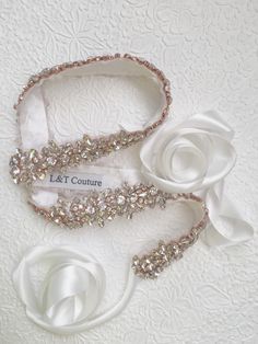 This belt/sash features clear crystals hand-placed a top of the ribbon. This beautiful sash is available in off white. Please let us know if you have any questions or need a custom order.  * Available in rose gold coated beading with clear crystals More sashes: https://www.etsy.com/shop/LTCoutureAtelier?ref=pr_shop_more&section_id=22035300 Back to LTCoutureAtelier shop:  https://www.etsy.com/shop/LTCoutureAtelier Bride Belt, Lace Top Wedding, Beaded Belts, Veil Crystal, Floral Veil, Bridesmaid Sash, Flower Veil, Bridal Accessories Jewelry, Wedding Sash Belt