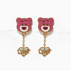 This lovable bear is in dire need of hugs, and now you can keep him close! With detailed handcrafted enamel to highlight Pixar Toy Story Lotso's adorable face, and a delightful drop chain attached to Daisy's heart pendant charm, you can embrace Lotso's sweet side with our Pixar Toy Story Lotso Dangle Earrings. Cute Charm Earrings For Gifts, Playful Pink Enamel Jewelry, Cute Earrings With Dangling Charms For Gifts, Enamel Heart Charm Earrings As Gift, Enamel Earrings With Heart Charm As Gift, Playful Pink Heart Earrings For Gift, Playful Pink Heart Earrings As Gift, Playful Dangle Jewelry For Gifts, Cute Enamel Dangle Jewelry