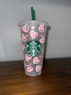 a starbucks cup with pink hearts on it