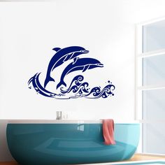 two dolphins jumping out of the water wall decal in a bathroom with blue tub