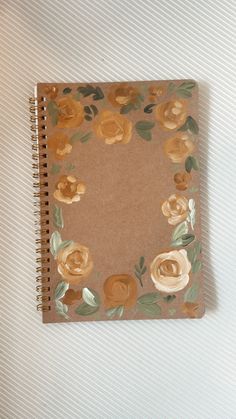 a brown notebook with flowers on it