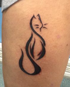 a black cat tattoo on the thigh