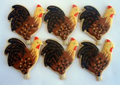 six decorated cookies in the shape of roosters