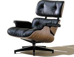 an eames lounge chair and ottoman in black leather with wood grained finish on the back