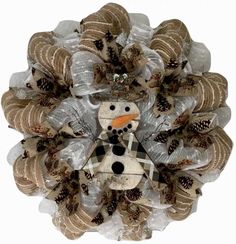 a snowman wreath made out of burlocks and pine cones