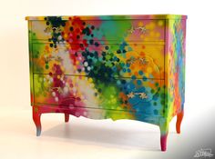 a multicolored dresser with lots of dots on it