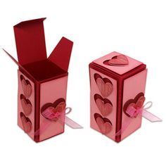 two pink boxes with hearts on them are sitting side by side, one is open and the other is closed