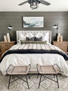 a white bed sitting in a bedroom under a ceiling fan