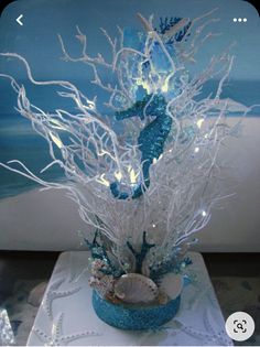 a blue and white vase with seahorses on it's sides is sitting on a table