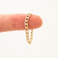 The beautiful Curb Chain ring is a must-have for your collection. Whether you're dressing up for date night or dressing down for a morning coffee with friends, this lightweight, chic ring is sure to add a bold touch you can't miss. It’s sure to make you feel gorgeous no matter what’s on your schedule for the day. DETAILS 14k gold filled -or- sterling silver chain & jump ring Available in sizes 5-8 Ring runs a tiny bit small - if you have a large knuckle, please size up Matching jewelry: Curb Cha Chain Ring Gold, Jewelry Photography Styling, Chic Rings, Coffee With Friends, Snake Chain Bracelets, Photography Styling, Matching Jewelry, Jewelry Photography, Ring Size Guide