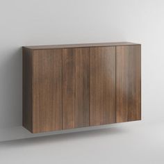 a wooden cabinet sitting on top of a white wall