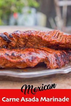 two pieces of meat sitting on top of a plate with the words mexican written above it