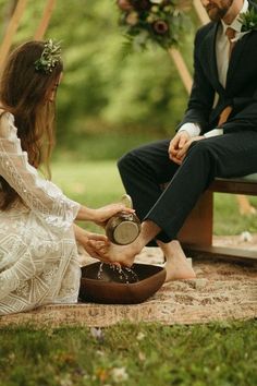 a man and woman are sitting on the ground