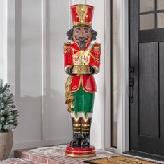 a large nutcracker statue sitting in front of a door