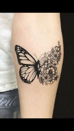 a butterfly and flowers tattoo on the arm