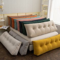 a bunch of pillows stacked on top of each other