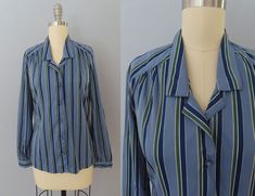 "Vintage 70's long sleeve disco blouse. Super soft in medium blue with dark blue, white and green vertical stripes. Cutaway collar with button-up front. Fabric colored buttons. Slim fit style. Long sleeves with button cuffs. Straight hem. Fits a modern day women's size large. Please see measurements below. MEASUREMENTS--Taken with garment laying flat, in inches, doubled: Chest: 42\"  Waist: 36\"  Shoulder: 16\" Sleeves: 23\" Length: 24\" Label/ Era: Panther| 1970 Fabric: Polyester, fabric covered buttons Condition: Excellent condition. Freshly laundered and no known issues. ★ Shop the entire shop here: https://www.etsy.com/shop/retrosuzysvintage Instagram | retrosuzysvintage Facebook | retrosuzysvintage Pinterest | retrosuzysvintage" Blue Long Sleeve Blouse With Vertical Stripes, Blue Vertical Stripes Button-up Blouse, Fitted Button-up Tops With Vertical Stripes, Fitted Vertical Stripe Button-up Tops, Fitted Blue Tops With Vertical Stripes, Blue Fitted Tops With Vertical Stripes, Fitted Blue Top With Vertical Stripes, Blue Fitted Top With Vertical Stripes, Fitted Vertical Stripes Button-up Blouse