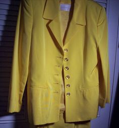 "Dana Buchman stunning yellow skirt suit. Shown with a silk Carlisle blouse which just happens to match the suit perfectly. I haven't listed the blouse yet as if the buyer of this suit would like it I will just include it at no additional charge. Jacket measures 38\" in the bust, length 26\". Waist on skirt measures 26\", hip 34\", length 20\". The blouse is a size 8 , bust 38\", length 20\". The fabric of the suit is acetate and cotton. No flaws of any kind. Stored with TLC. Comes from a smoke- Yellow Silk Sets For Spring, Classic Fitted Yellow Sets, Classic Yellow Fitted Sets, Elegant Tailored Yellow Sets, Spring Formal Yellow Set, Elegant Yellow Summer Sets, Tailored Skirt Suit For Formal Summer Events, Tailored Skirt Suit For Summer Formal Events, Formal Summer Sets With Buttons