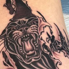 a black and white tattoo of a tiger