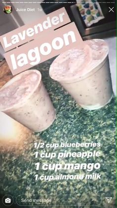 two drinks sitting on top of a counter next to a sign that says lavender lagoon