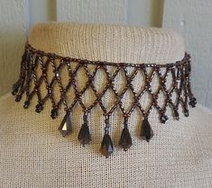 To bead this choker, I did netted weave using: twisted, bronze, bugle beads, brown and black, size 8 and 10, seed beads, and bronze, faceted, Czech glass drop beads.   Because I added an extender, the length is adjustable; starting at 30.5 cm. (12"), up to 47.5 cm. (18 3/4").  It closes with a black, lobster claw clasp. If you would prefer the tail loop up rather than dangle, just let me know at time of purchase, and I can easily add a hook. at at the end. The last photo shows more of my work.   If you don't see the listing in my shop, contact me and, chances are, if I don't have it in stock I can probably make a custom necklace for you. This is a simple version of the amazing collars made by Native-Americans, for centuries, up to the present.  To see some examples, go to the National Muse Black Beaded Choker, Bugle Bead Patterns, Elegant Evening Wear, Simple Choker, Black Seed, Bugle Beads, Beaded Jewelry Patterns, Beaded Choker Necklace, Drop Beads