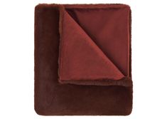 a brown and red blanket folded on top of each other