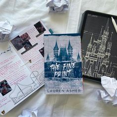 some papers are laying on top of a bed with the castle drawn on it and other items